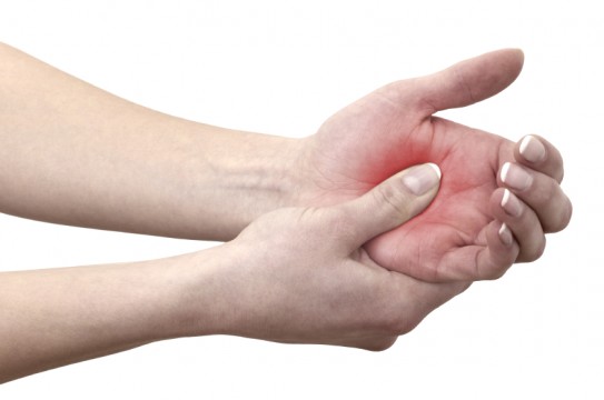 Acute pain in a woman palm. Concept photo with blue skin with read spot indicating pain. Isolation on a white background